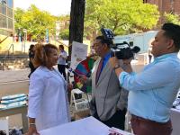 Ashanda Saint Jean, MD speaks to local media at the Healthy Haven festival